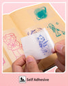 Phomemo self-adhesive transparent thermal stickers with printed cartoon animals applied to a notebook