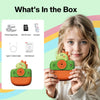 Girl holding Phomemo dinosaur kids photo printer, with box contents including print paper, SD card & USB cable.